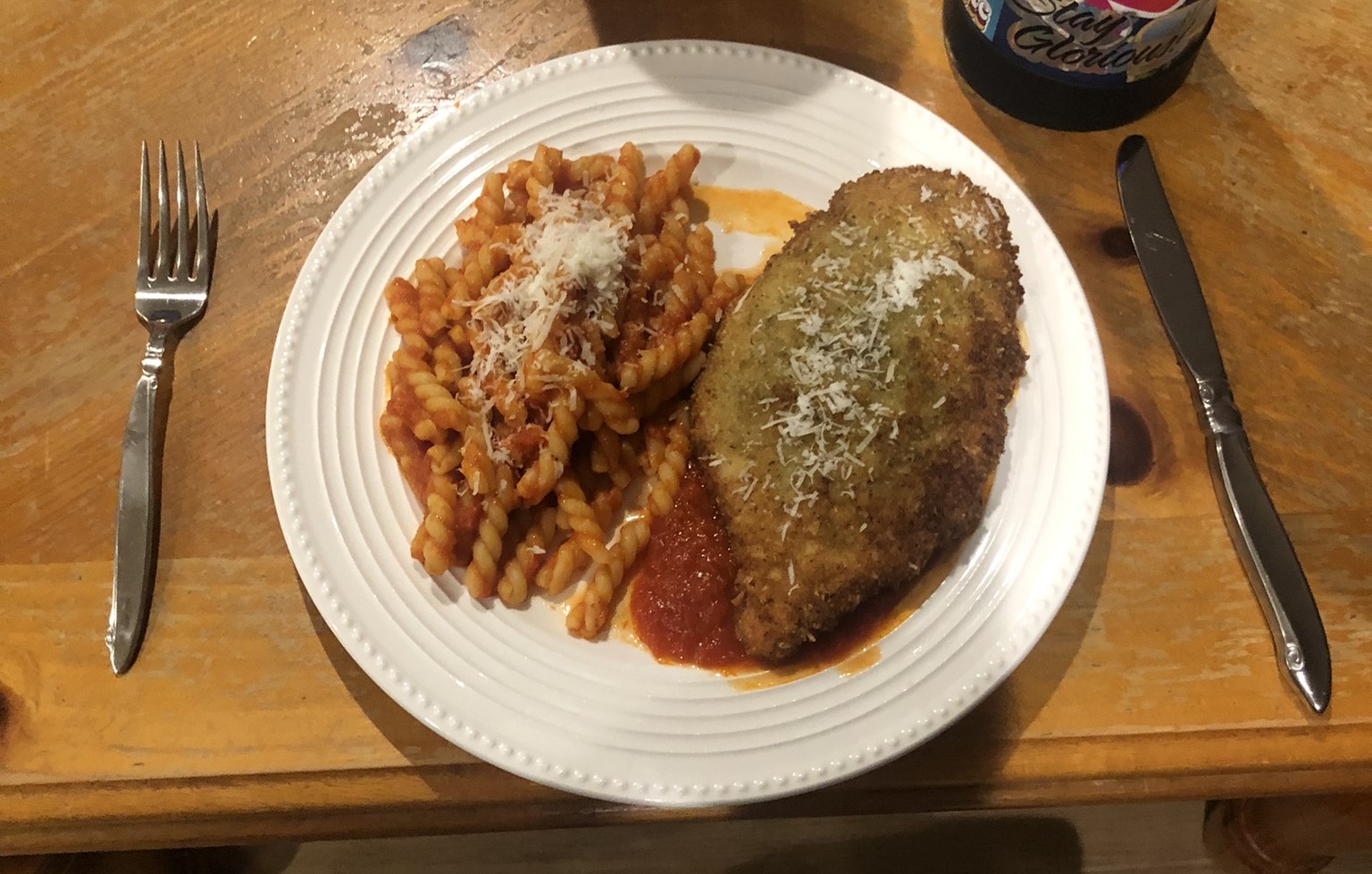 Chicken parmesan, plated with marinara pasta